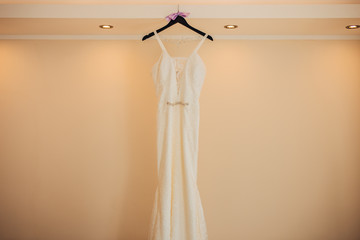 The bride's dress on a hanger in the room in Montenegro