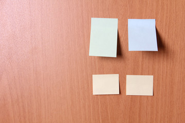 Empty sheets of paper on a wooden wall