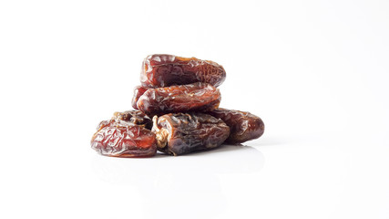 Date fruits on white background. Selective focus.