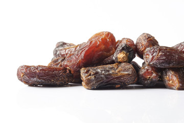 Date fruits on white background. Selective focus.