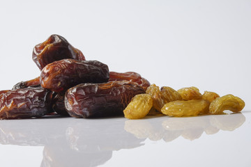 Dates and raisin isolated on white.