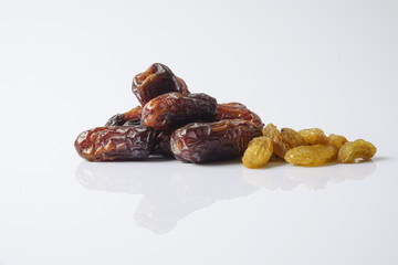 Dates and raisin isolated on white.