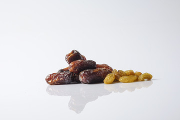 Dates and raisin isolated on white.