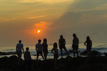 Girls Boys Silhouetted Beach Ocean Sunrise rocky coastline landscape
