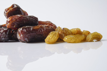 Dates and raisin isolated on white.