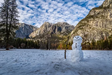Fototapete Snowman at Yosemite Valley during winter with Upper Yosemite Falls on background - Yosemite National Park, California, USA © diegograndi