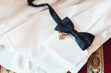 bowtie and cufflinks on a white shirt