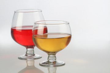 Red and White Wine Glasses with Reflection on White