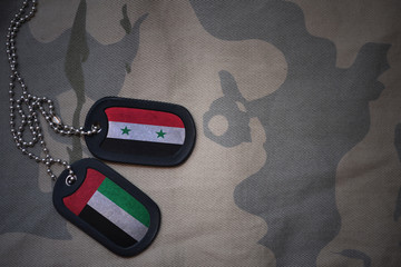 army blank, dog tag with flag of syria and united arab emirates on the khaki texture background....