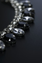 black and white jewelry with dark background. low key picture style of commercial product.