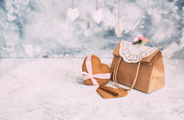 Hearts shaped cookies with paper bag over vintage background. Copy space