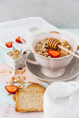 Oat flakes in bowl and fruits. Milk and honey. Wooden background. Top view