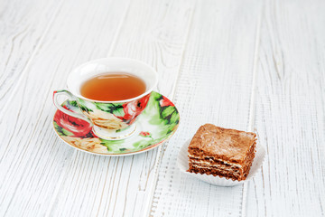 The piece of chocolate cake and a cup of tea. The concept of food and dessert.