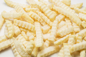 Freeze potato stick on the white plate.