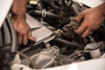 Close up Mechanic hands holding on engine cap after change new engine oil.