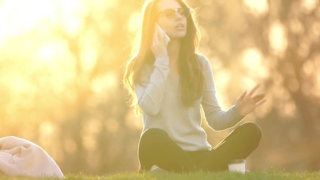 Angry displeased woman talking on phone and repeating 'no' in park