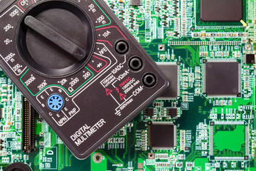 Fragment of a digital multimeter closeup on a printed circuit board