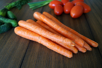 Colorful close up photo of vegetables like carrots from garden on the dark wood finish table