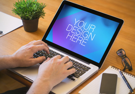 User with Laptop at Desk Mockup 1