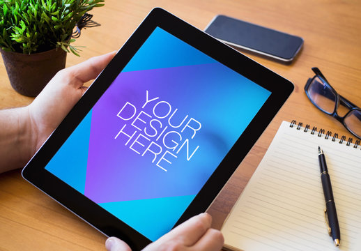 User with Tablet at Desk Mockup 1