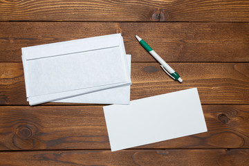 Blank paper, envelope on wooden table