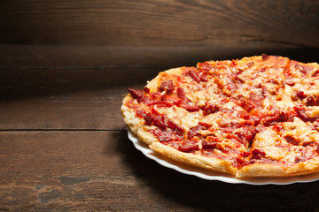 round pizza on wood background