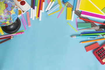 School supplies on the light blue background.