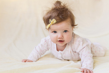 Fototapeta premium A small child laughing and learning to crawl.