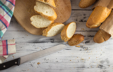 French baguette cut with a knife on cutting board