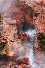 magical pool with boiling geothermal water of Iceland, mineral walls and steam