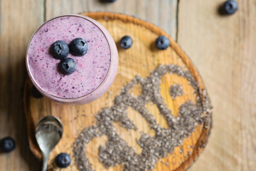 Raspberries, blueberries chia smoothie with touch of honey, served in a round glass