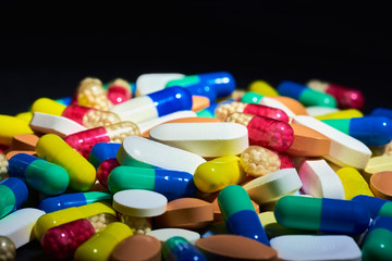 Medicine Pills. Tablets. Capsule.Pharmaceutical medicament, Close-up of pile of blue and green tablets - capsule. Pills and tablets on black background