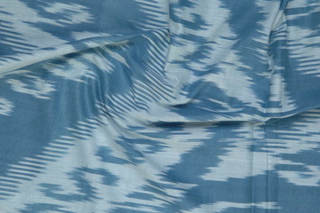 background of silk fabric with oriental ornaments. uzbek silk with ornament