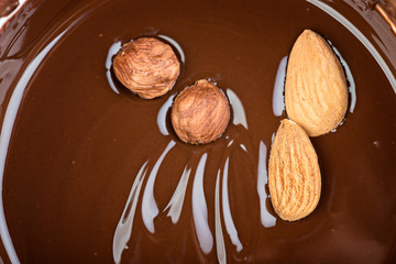 Melted chocolate swirl   background with nuts