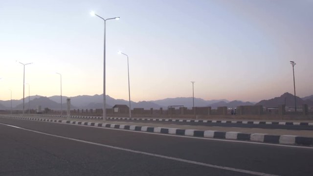 Lonely road near the desert mountains