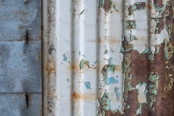 corrugated iron surface is covered with old paint, chipped paint, texture background