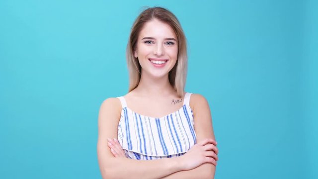 Young blonde woman wearing dress smiling  isolated