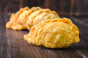curry puff pastry on wooden board background