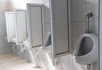 White, clean men toilet in a row