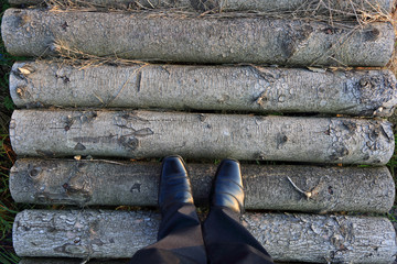 Nogi w butach na drewnianej kładce.