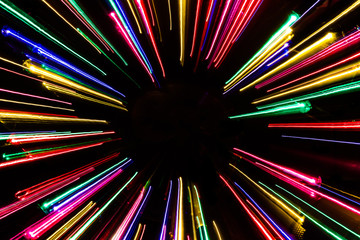 Colorful neon light lines on black background.