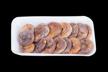 Dried figs on a plate isolated on a black background