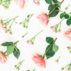 Floral pattern made of pink roses, buds and leaves isolated on white background. Flat lay, top view.