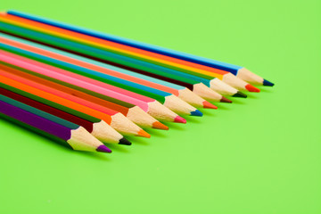 Colored pencils on a green background