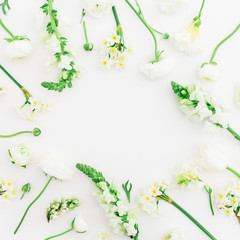 Round frame of white ranunculus, snapdragon, lilac and tulip on white background. Flat lay, top view.