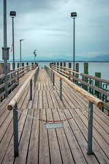Fototapeta premium Pier for passenger boats at Chiemsee lake. Women s island, Chiemsee lake, Bavaria, Germany