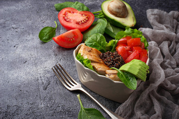 Salad with chicken, black quinoa, tomatoes and avocado