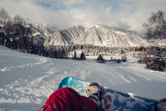 First Person Is Sitting On The Snowing Hill