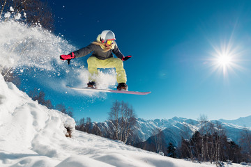 Girl is jumping with snowboard