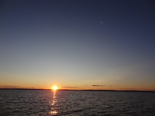 Fototapeta na wymiar Beautiful sunset with dark sky and Vättern lake in Sweden